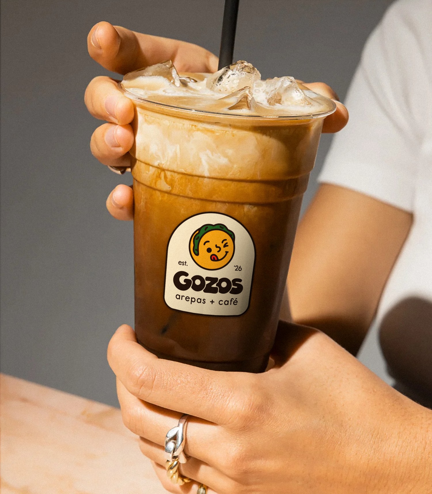 Iced coffee cup with the Gozos lockup