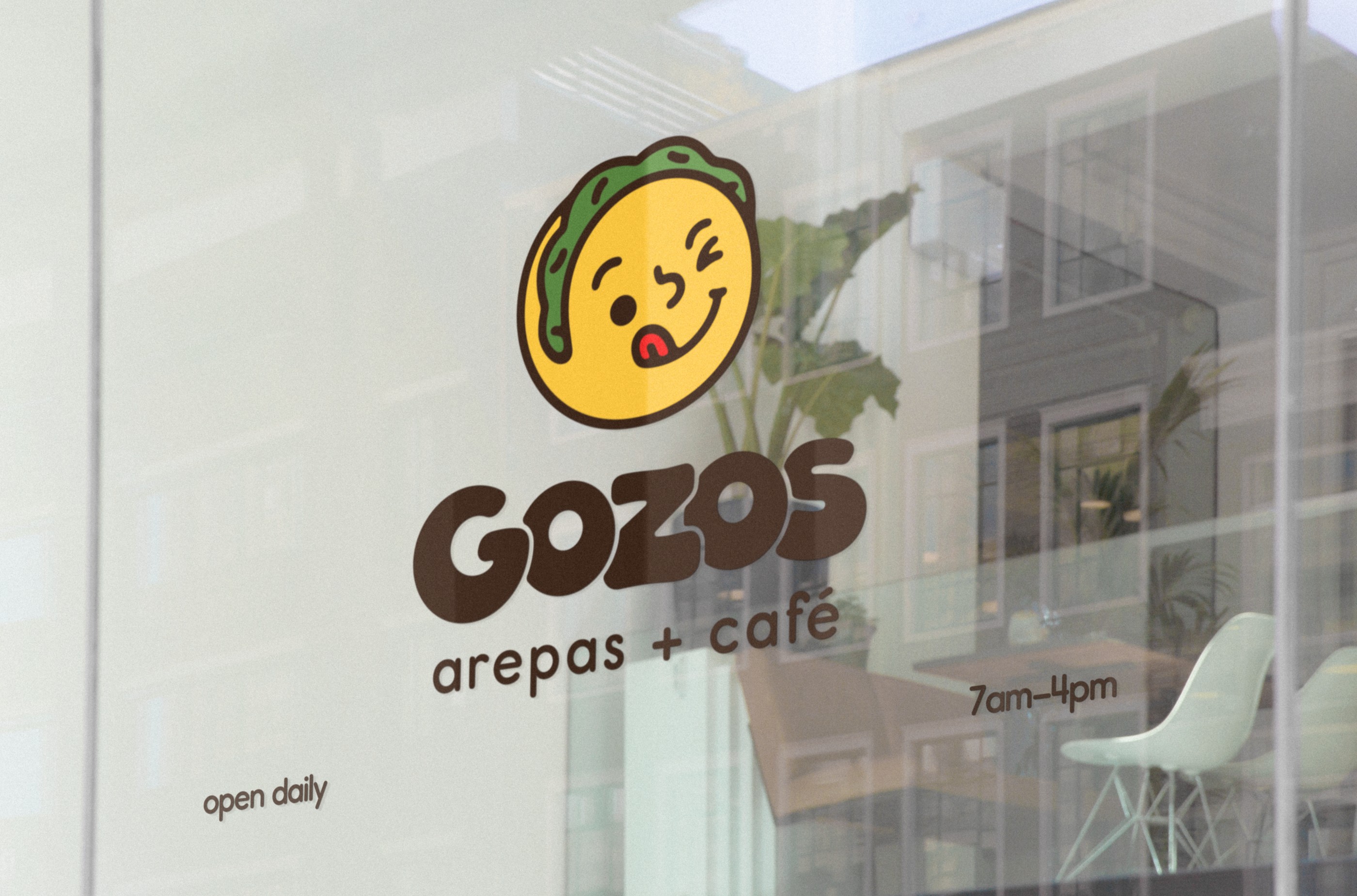 Gozos storefront window with the mascot, wordmark and opening hours