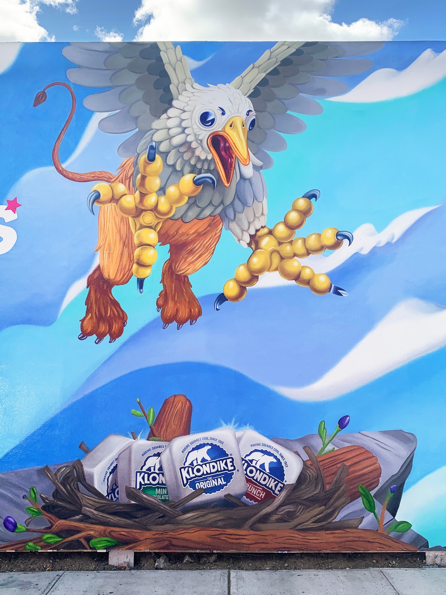 The griffin section of the mural, claws out over a nest of Klondike bars